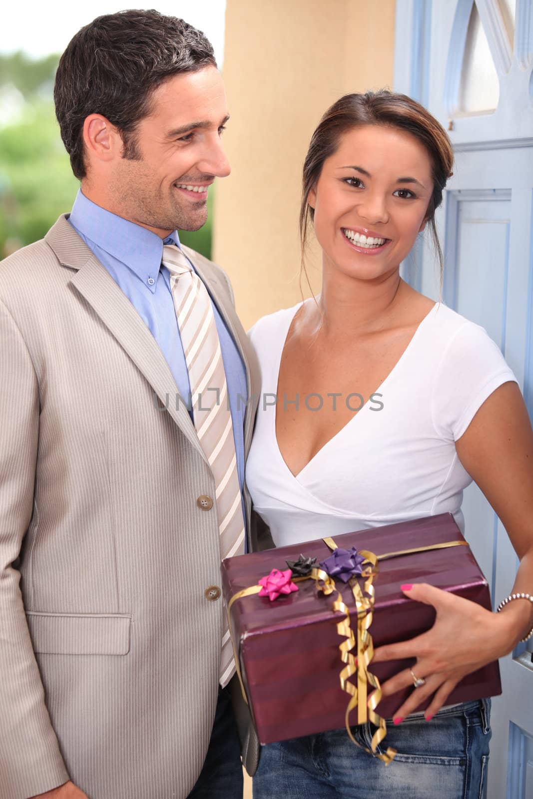 a beautiful woman received a gift from a well dressed man by phovoir