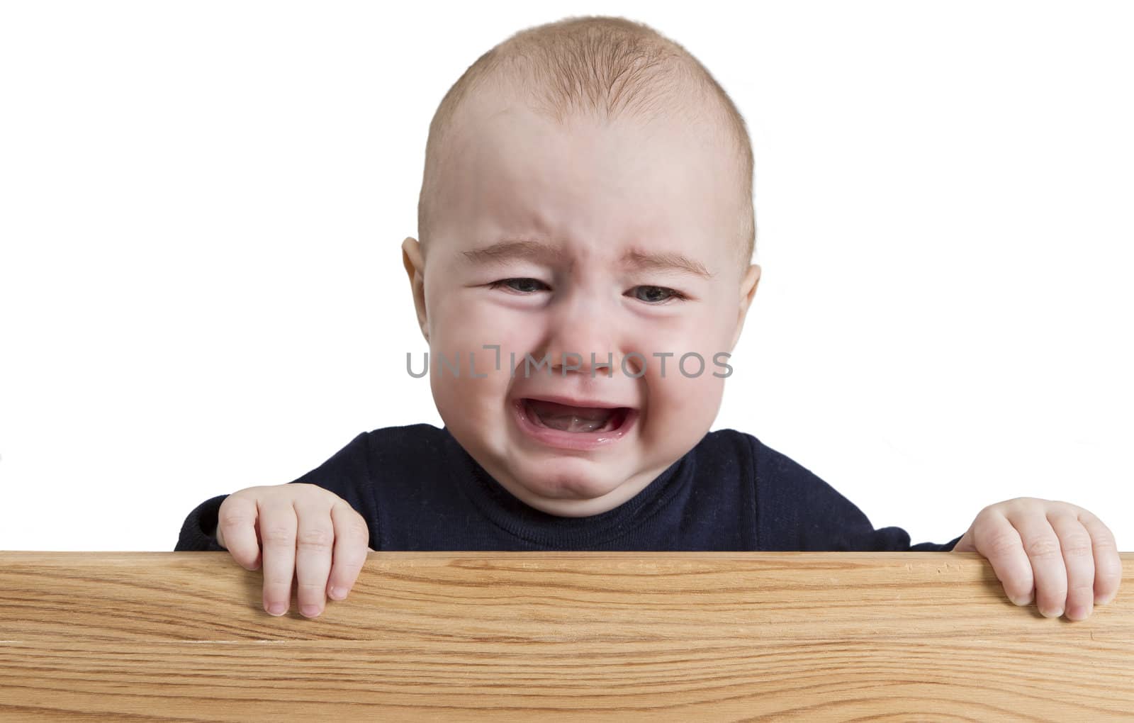 crying young child holding board. isolate on white background