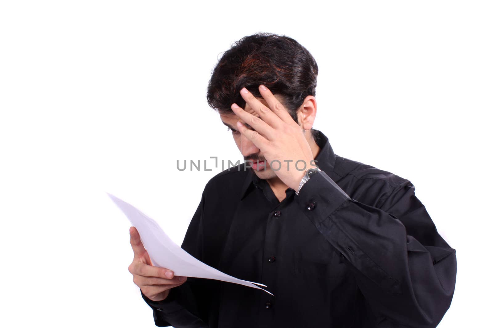 A stressed Indian guy looking at the bills he has to pay, on white studio background.