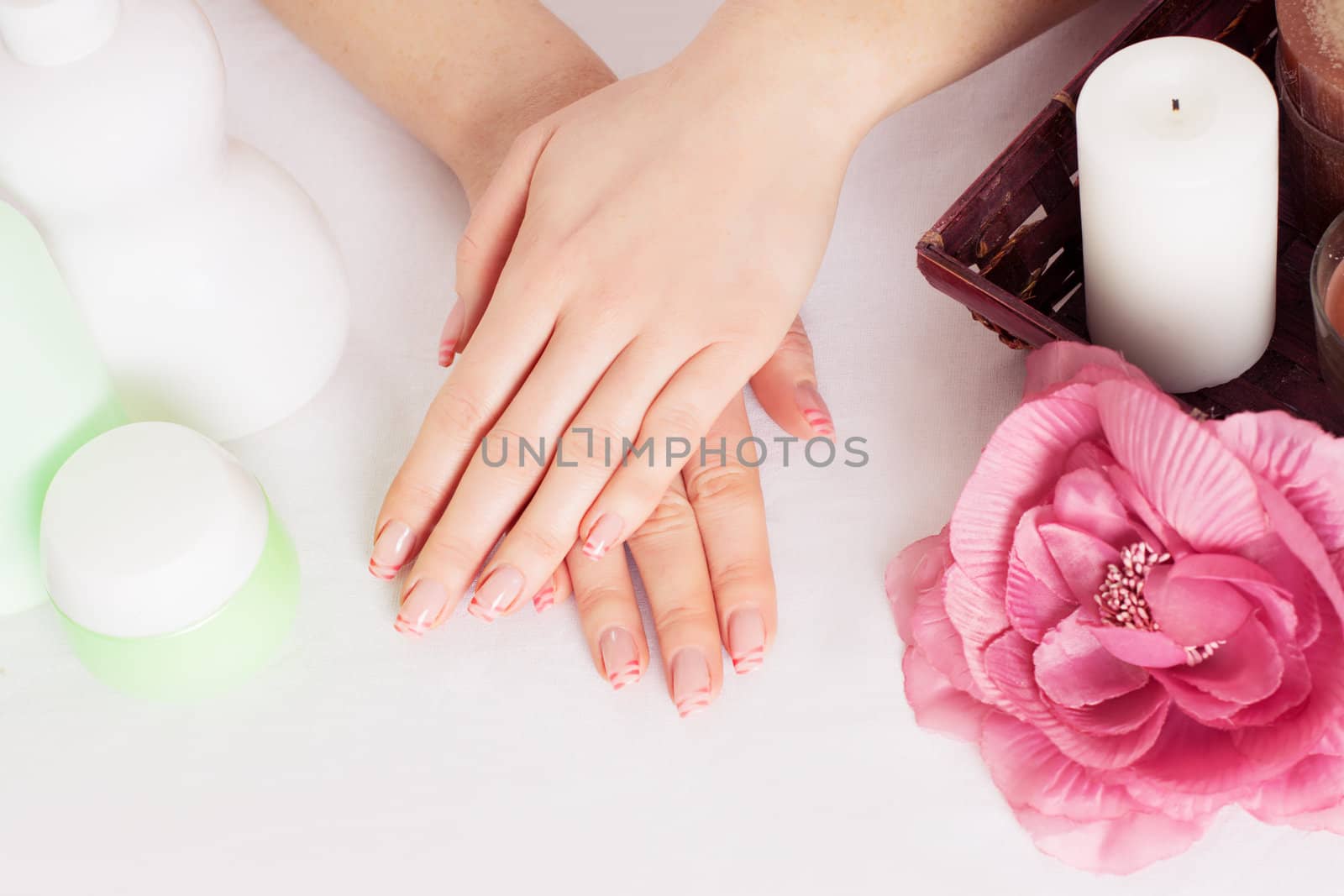 Woman hands with manicure and hand care products