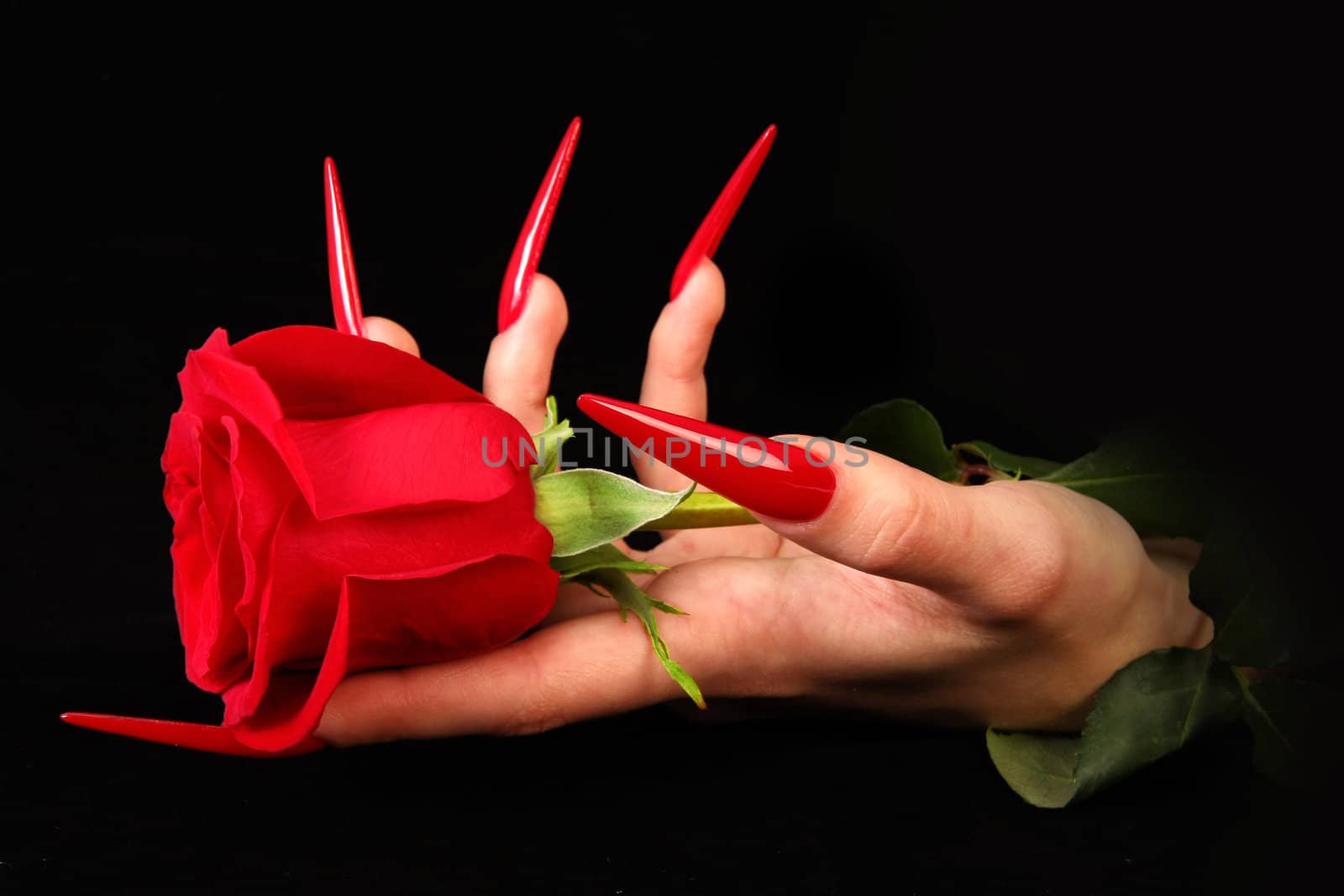 Human fingers with long fingernail and beautiful manicure isolated on black