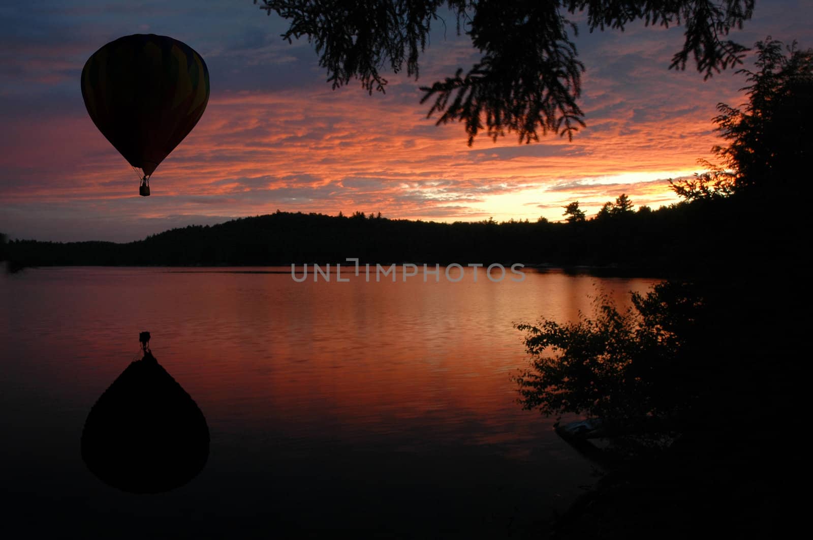 Hot-Air Balloon over Lake at Sunset Sunrise