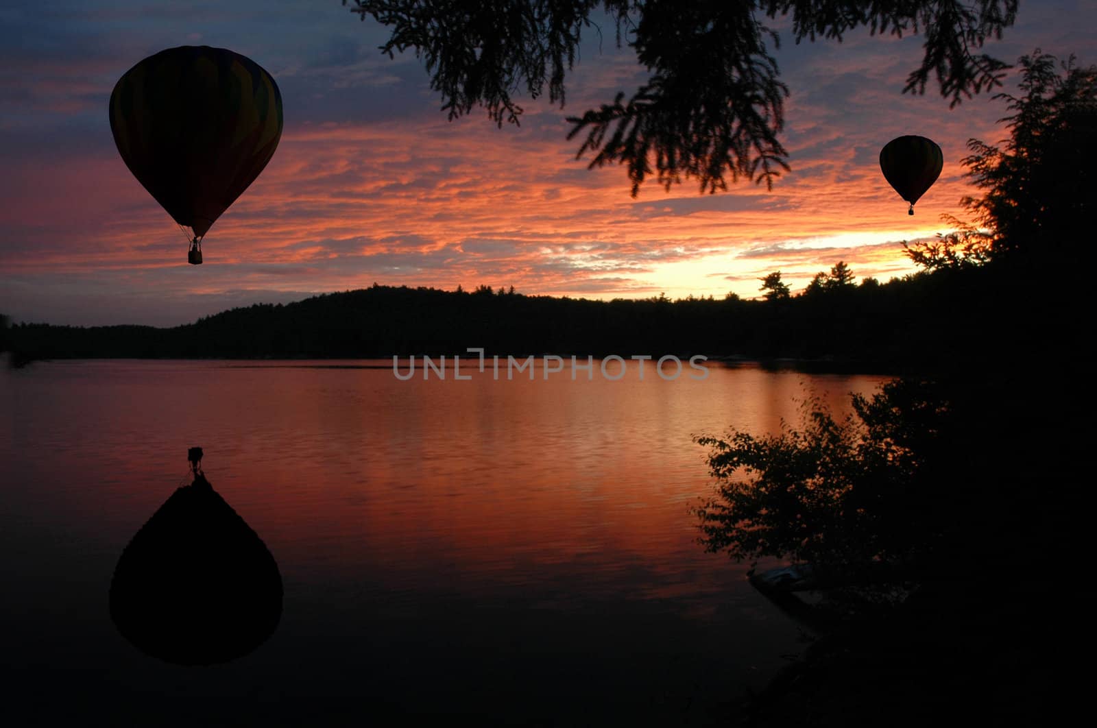 Hot-Air Balloons over Lake at Sunset or Sunrise