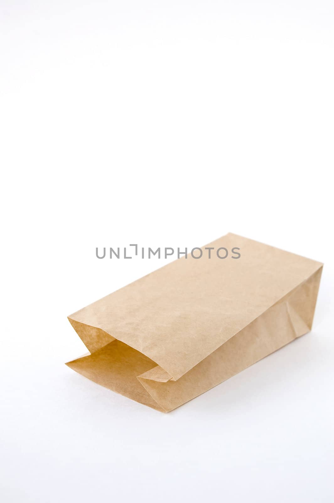 open brown paper bag on white background