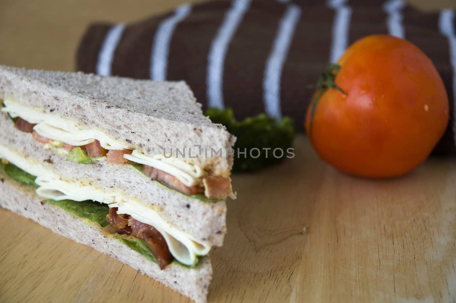 close up gaba bread sandwich with fresh tomato on wooden table