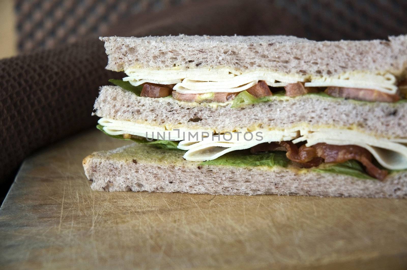 close up layer of chicken and bacon baga bread sandwich