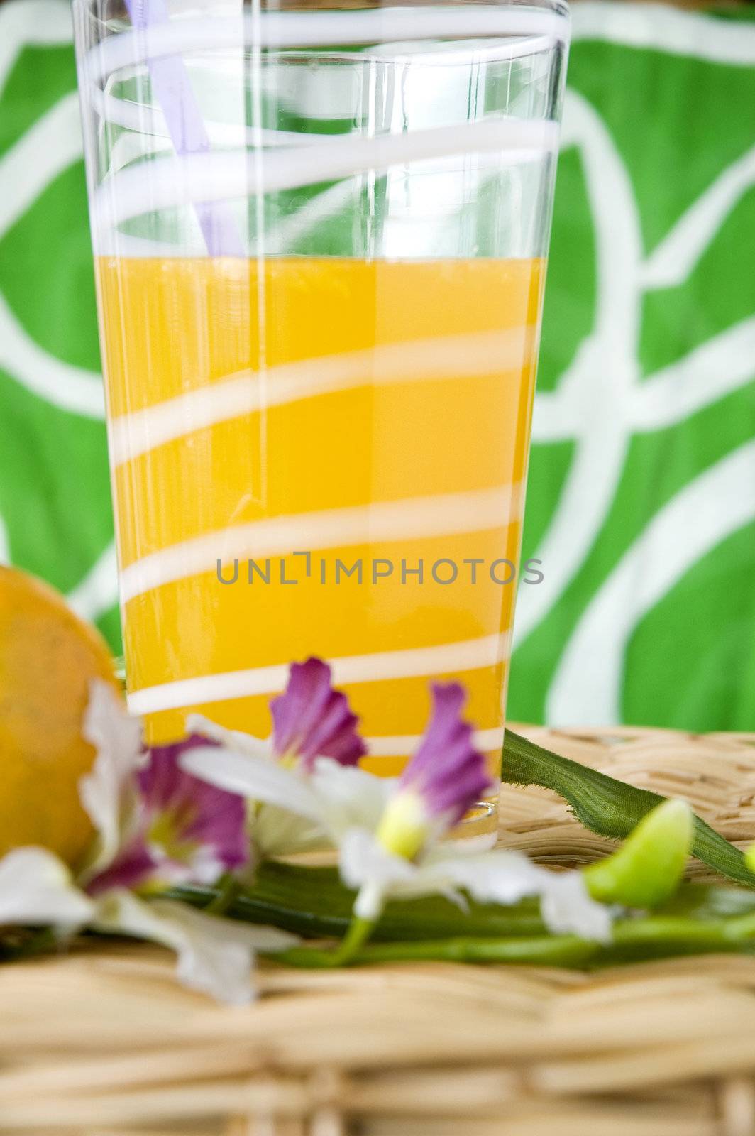glass of fresh orange juice put with flower