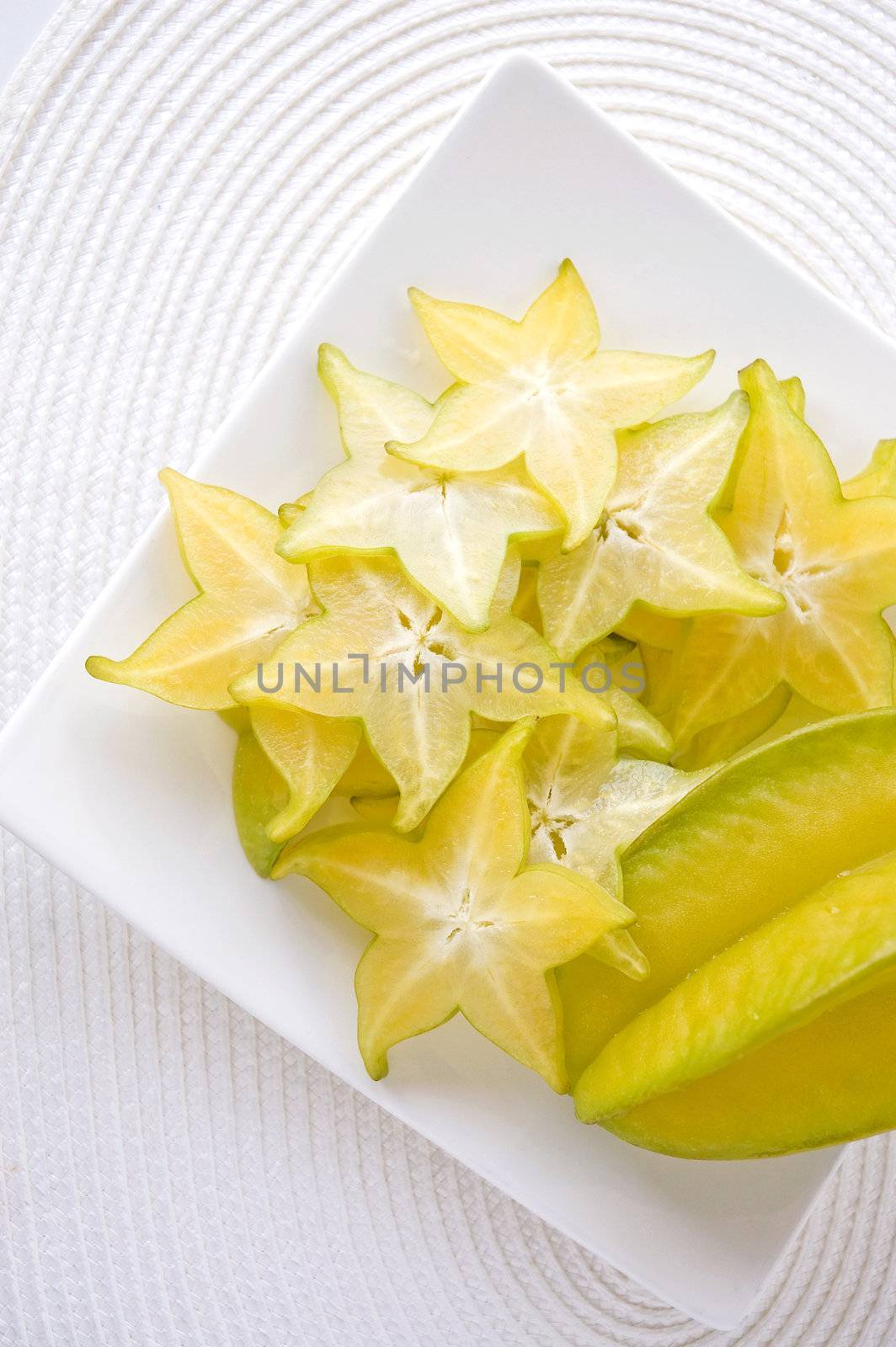 sliced fresh starfruit serve on white plate