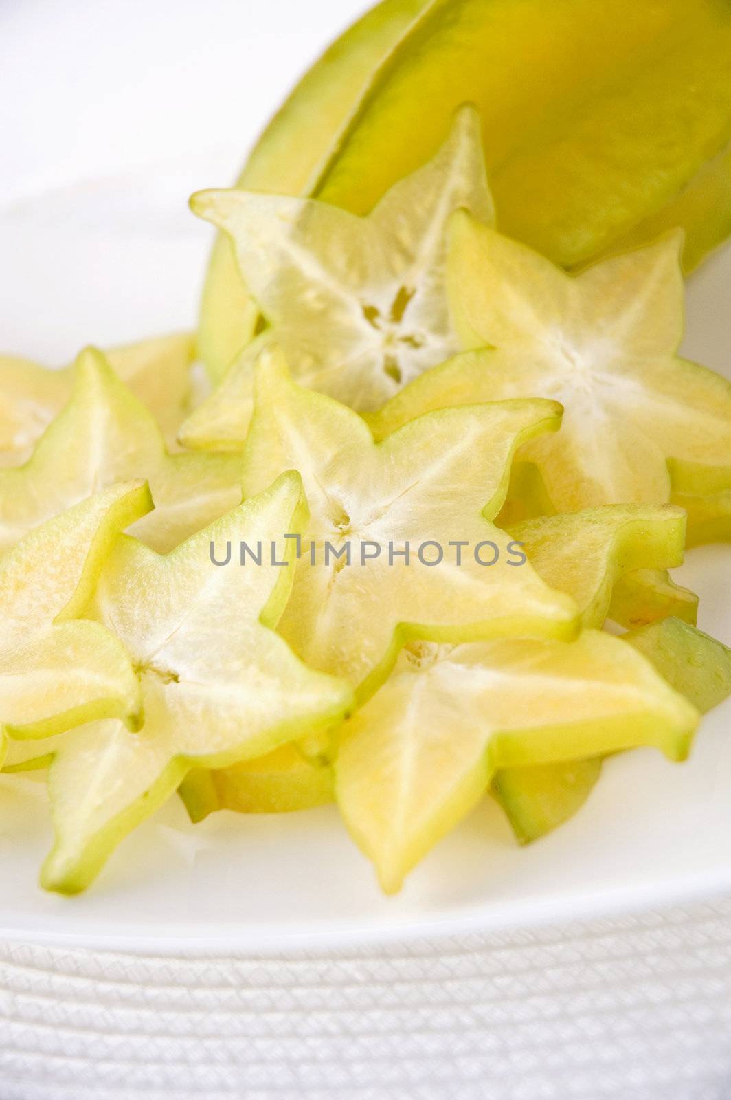 fresh carambola, starfruit on white plate