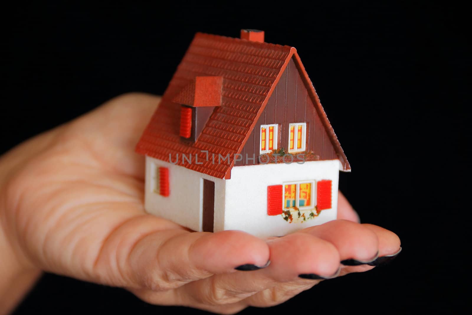Image of house with red roof in hand