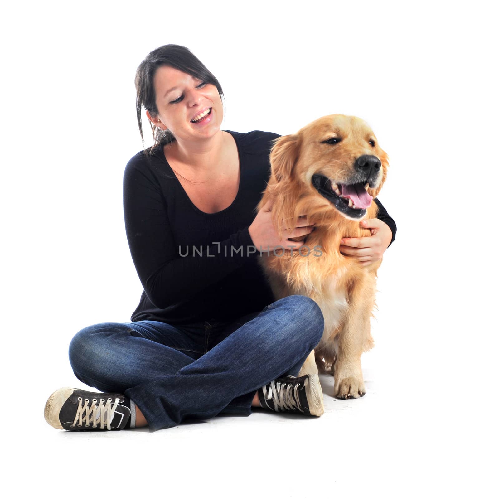 purebred golden retriever and woman in front of a white background