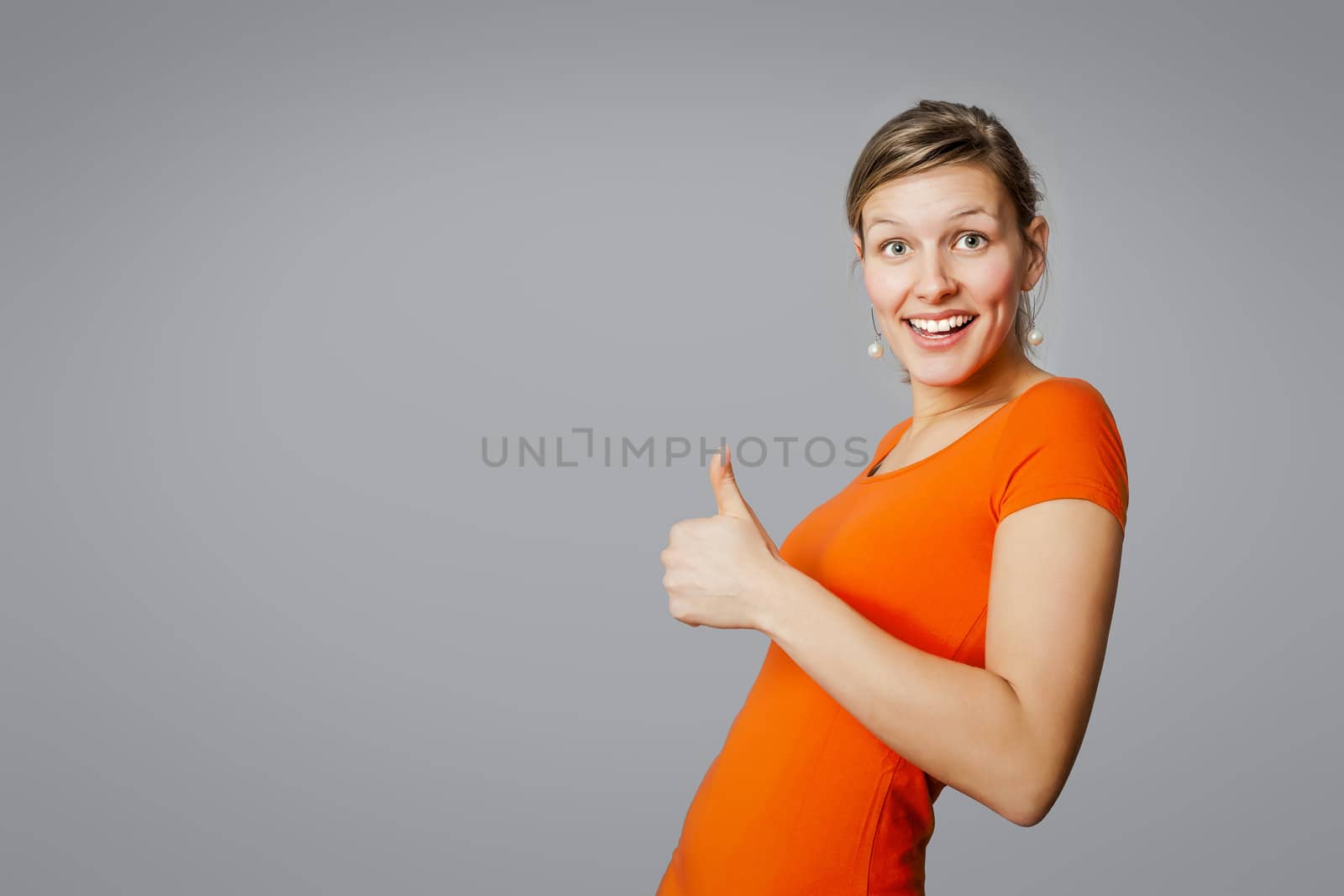 An image of a young woman with a thumb up