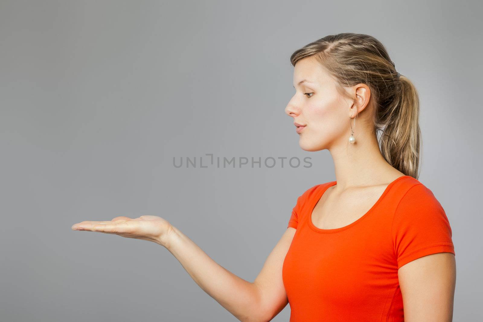 An image of a nice young woman presenting something