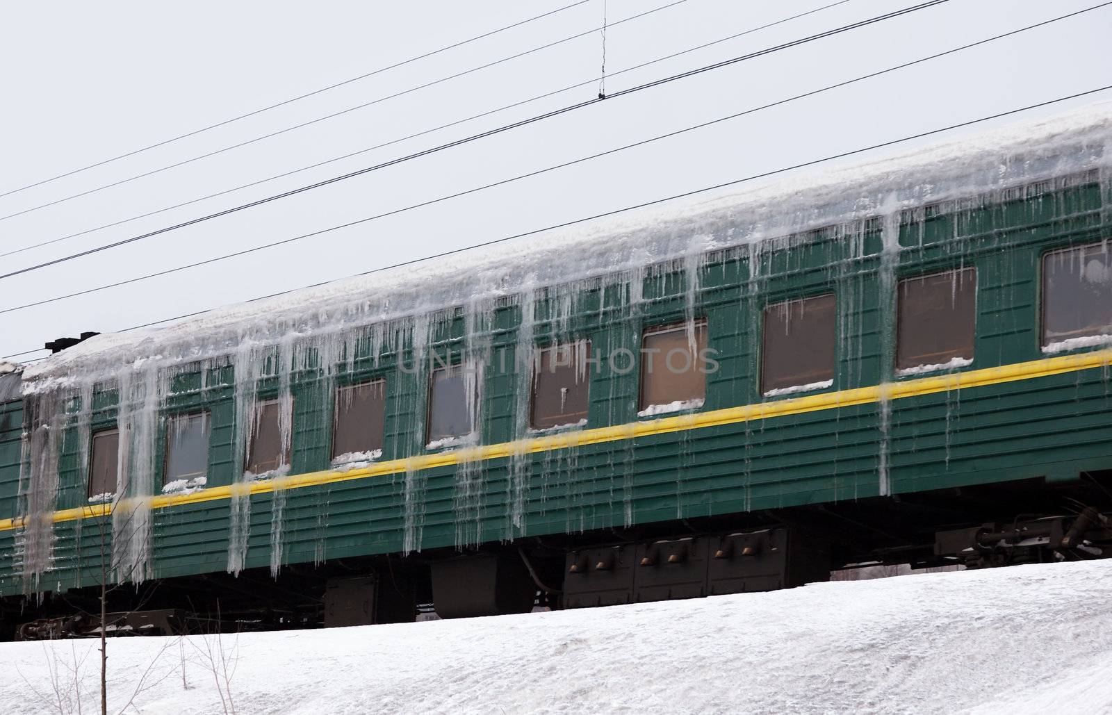 Passenger train covered with ice in snow