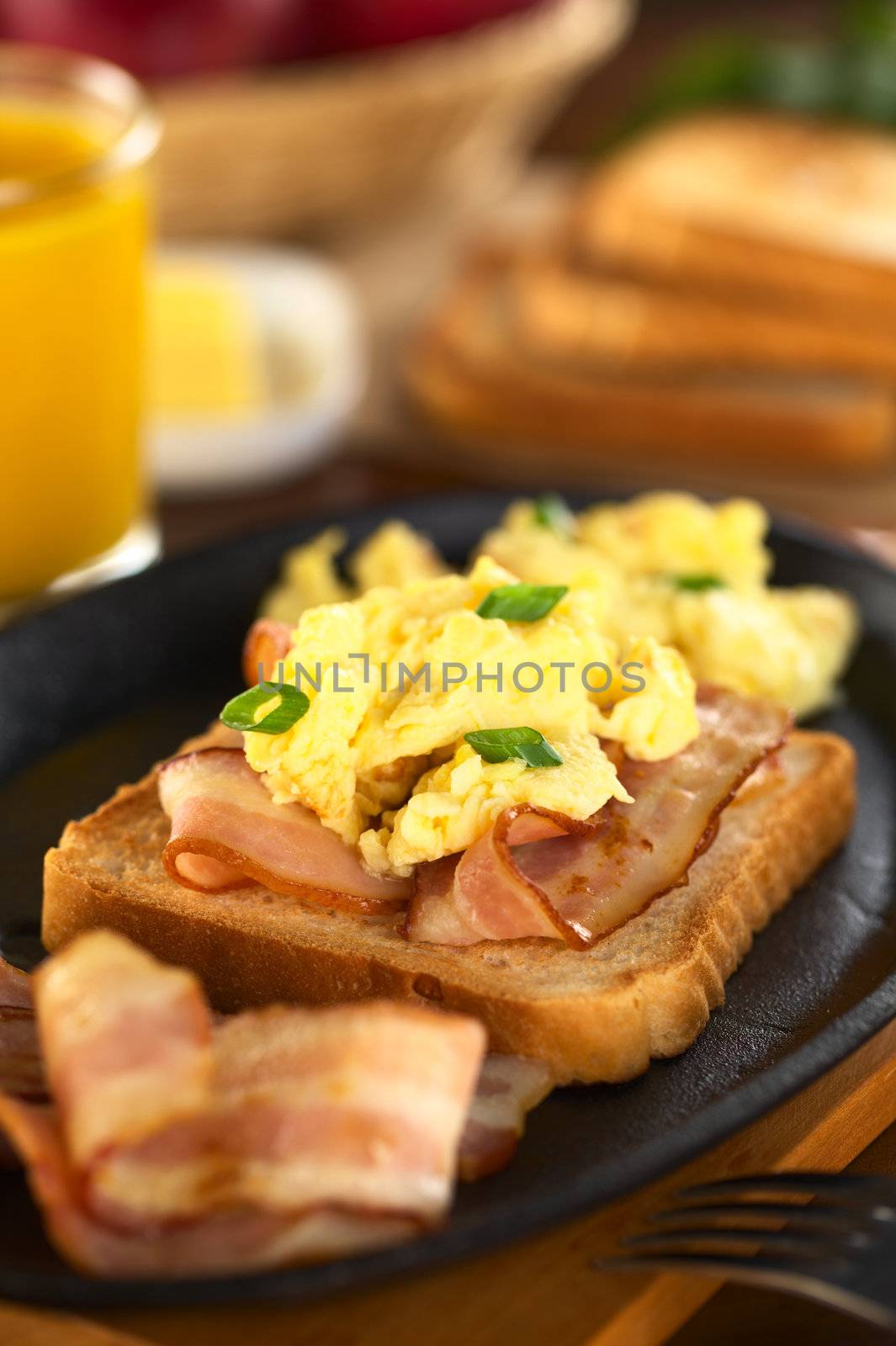 Fried bacon and scrambled egg on toast bread (Selective Focus, Focus on the front of the shallot in the front) 