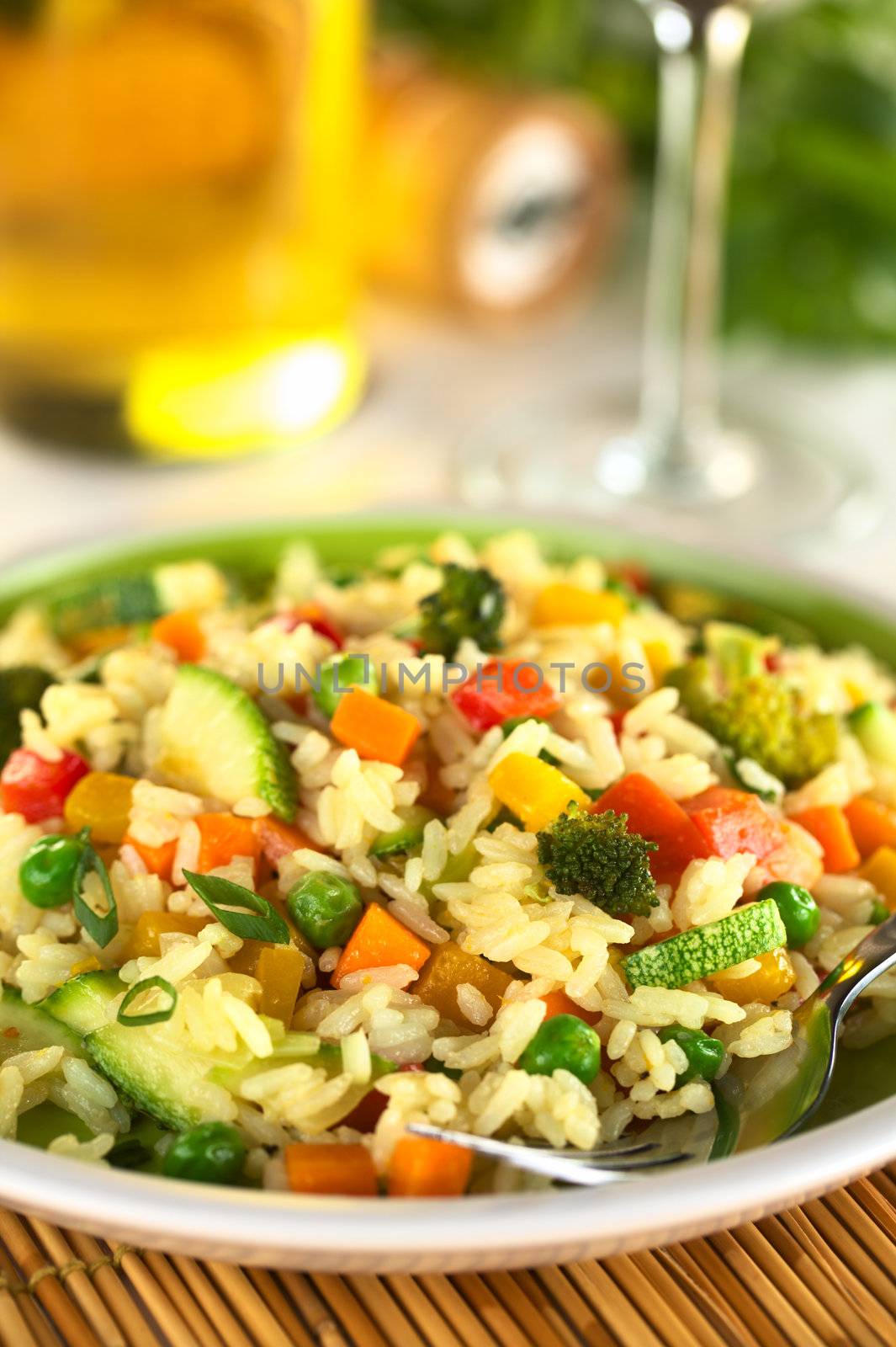 Vegetable risotto made of zucchini, pea, carrot, red bell pepper, broccoli and pumpkin (Selective Focus, Focus on the broccoli in the front) 