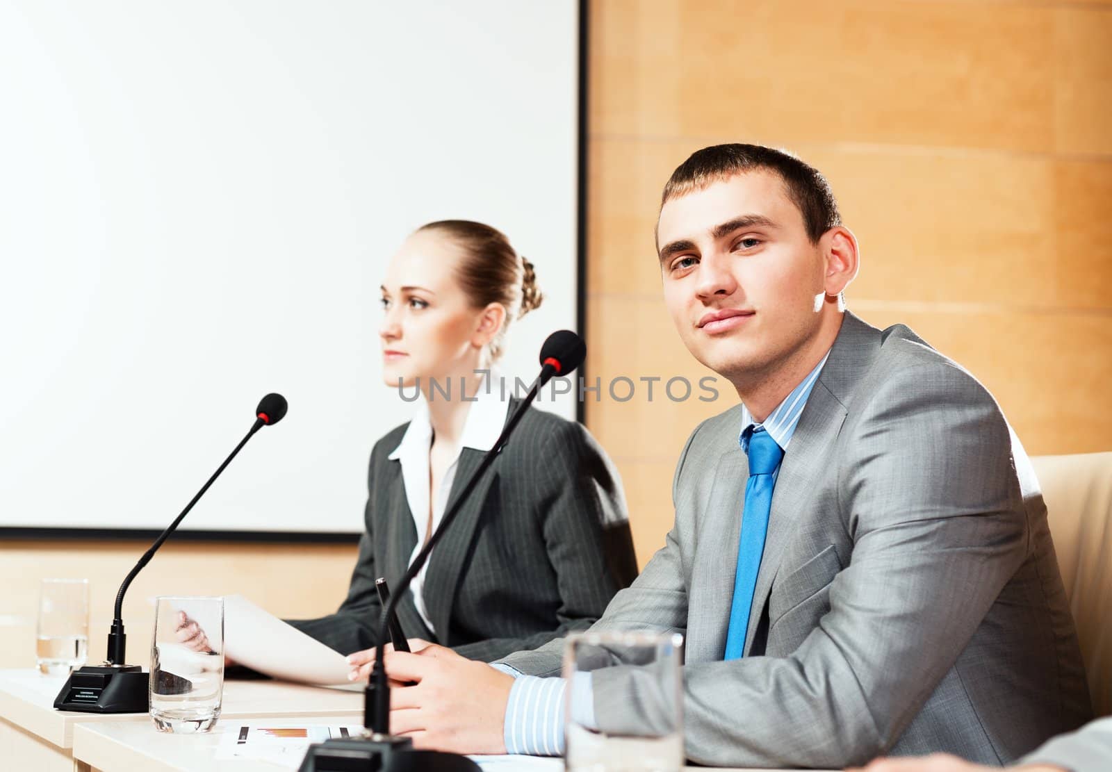 businessmen communicate at the conference, man looking at the camera