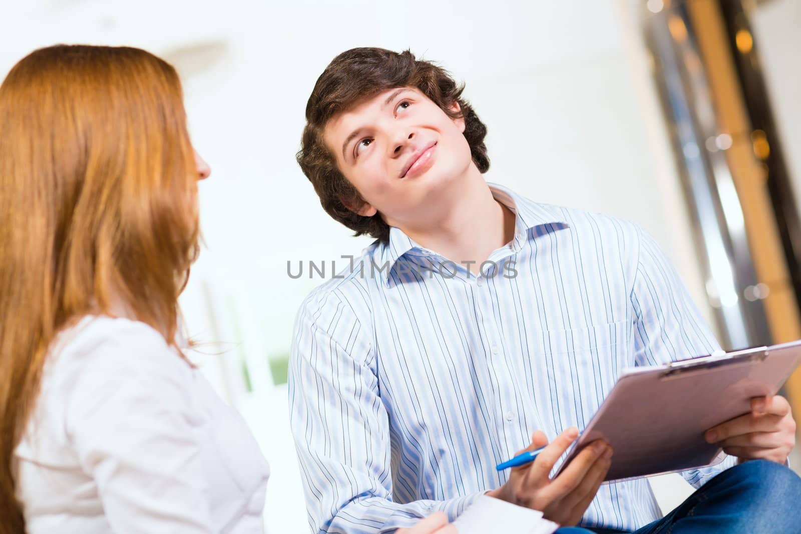 young European businessman holding tablet and looking up