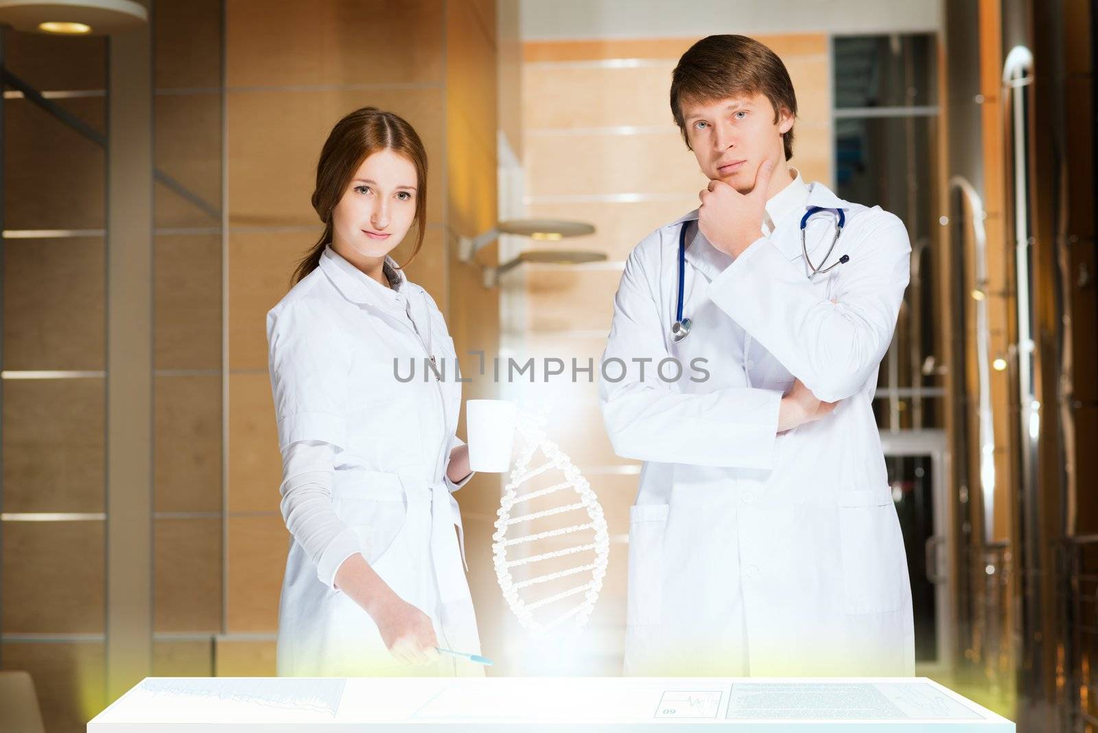 two doctors stand near glowing table discussing. projected objects on a desk