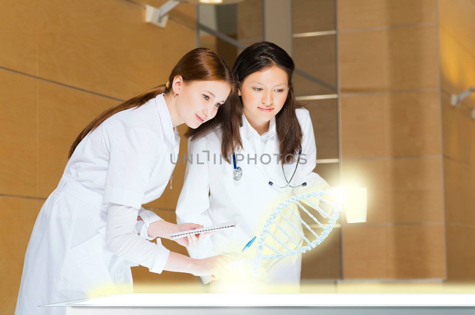 two doctors stand near glowing table discussing. projected objects on a desk