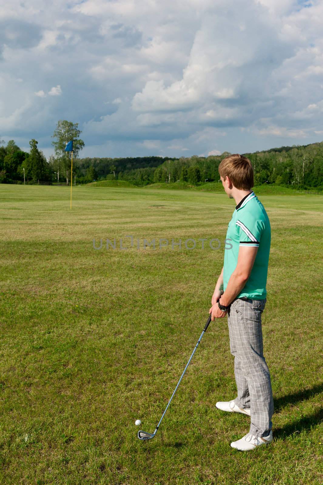 Man stay on green golf field. recreation