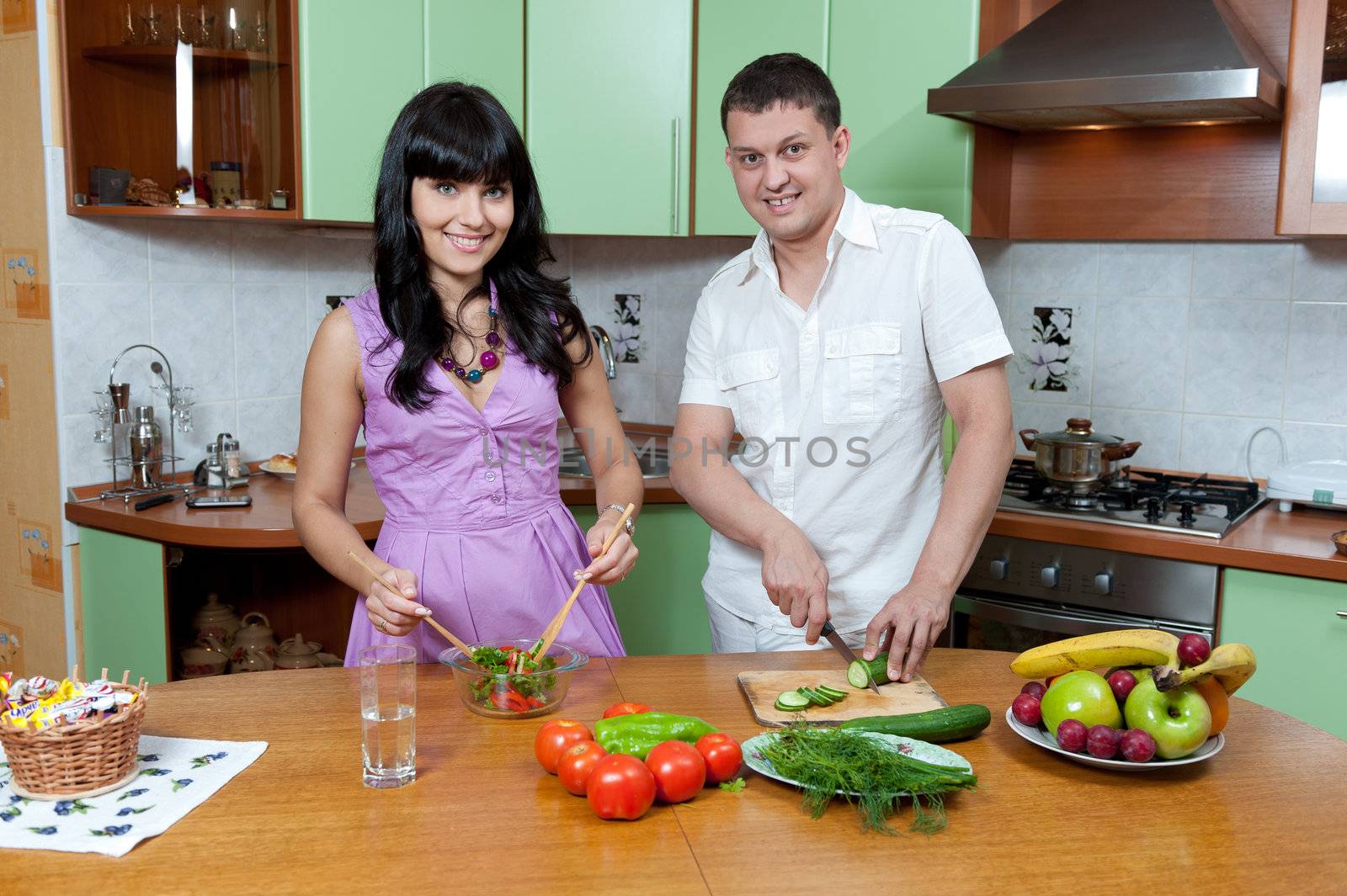 Portrait of a Happy couple preparing food in the kitchen