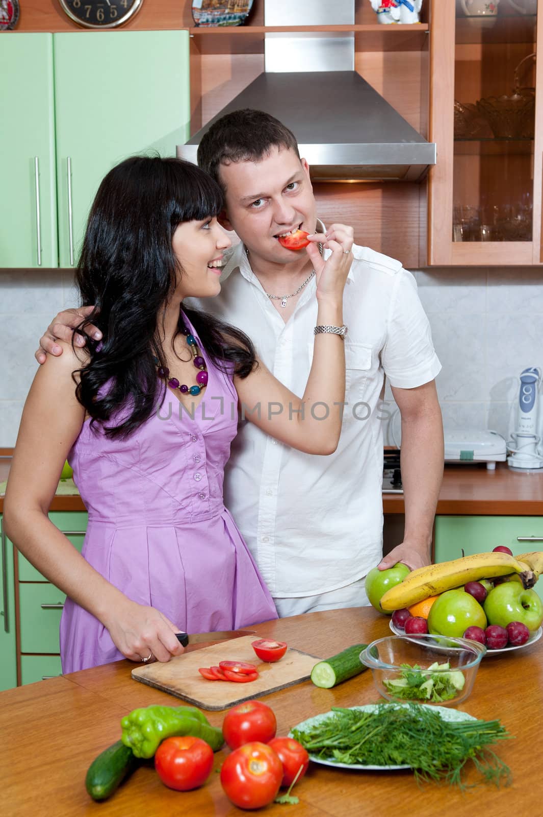 Portrait of a Happy couple preparing food in the kitchen
