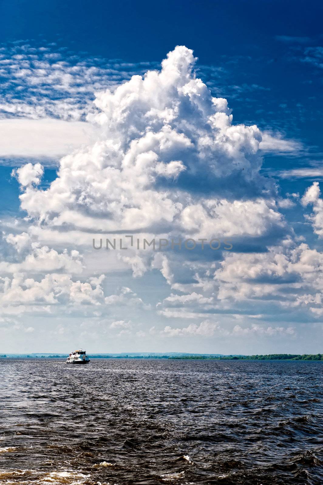 boat on a river. great swirling clouds