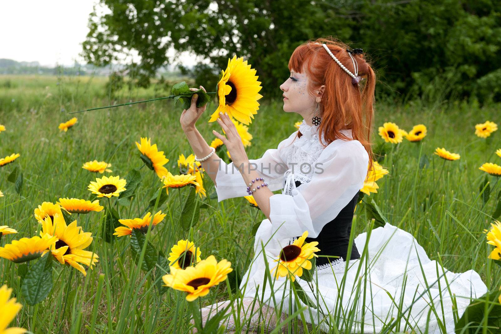 red-haired nymph in a white dress on a fairy glade