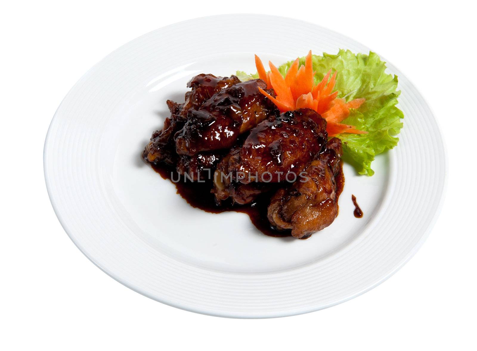 Roast chicken wings on a plate isolated on white background