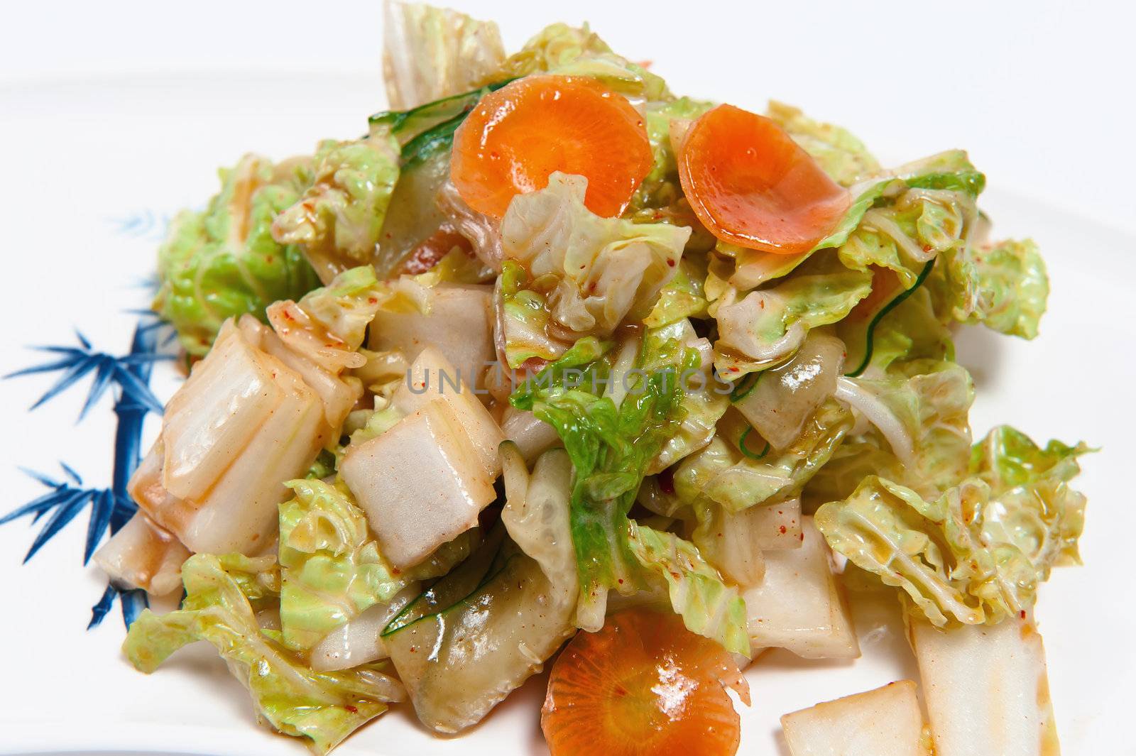 Salad with an octopus on plate isolated on white