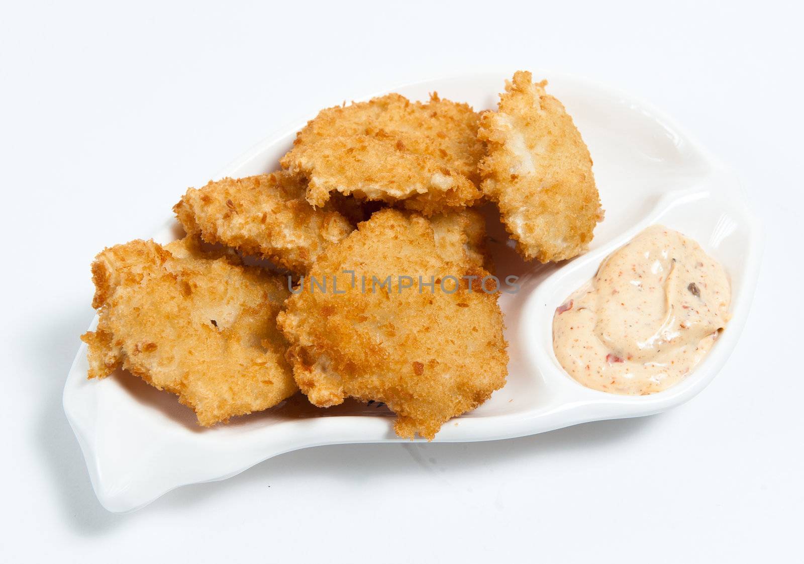 chicken nuggets with sauce on the plate isolated on white