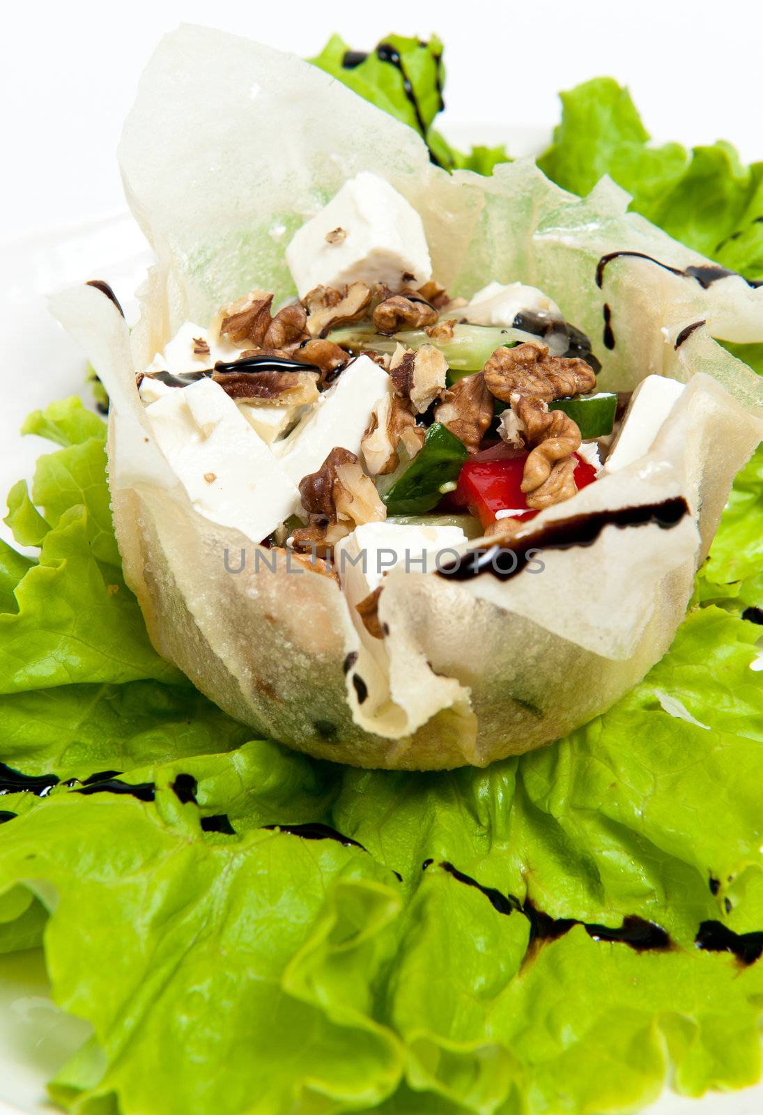 Greek salad on plate isolated on white background