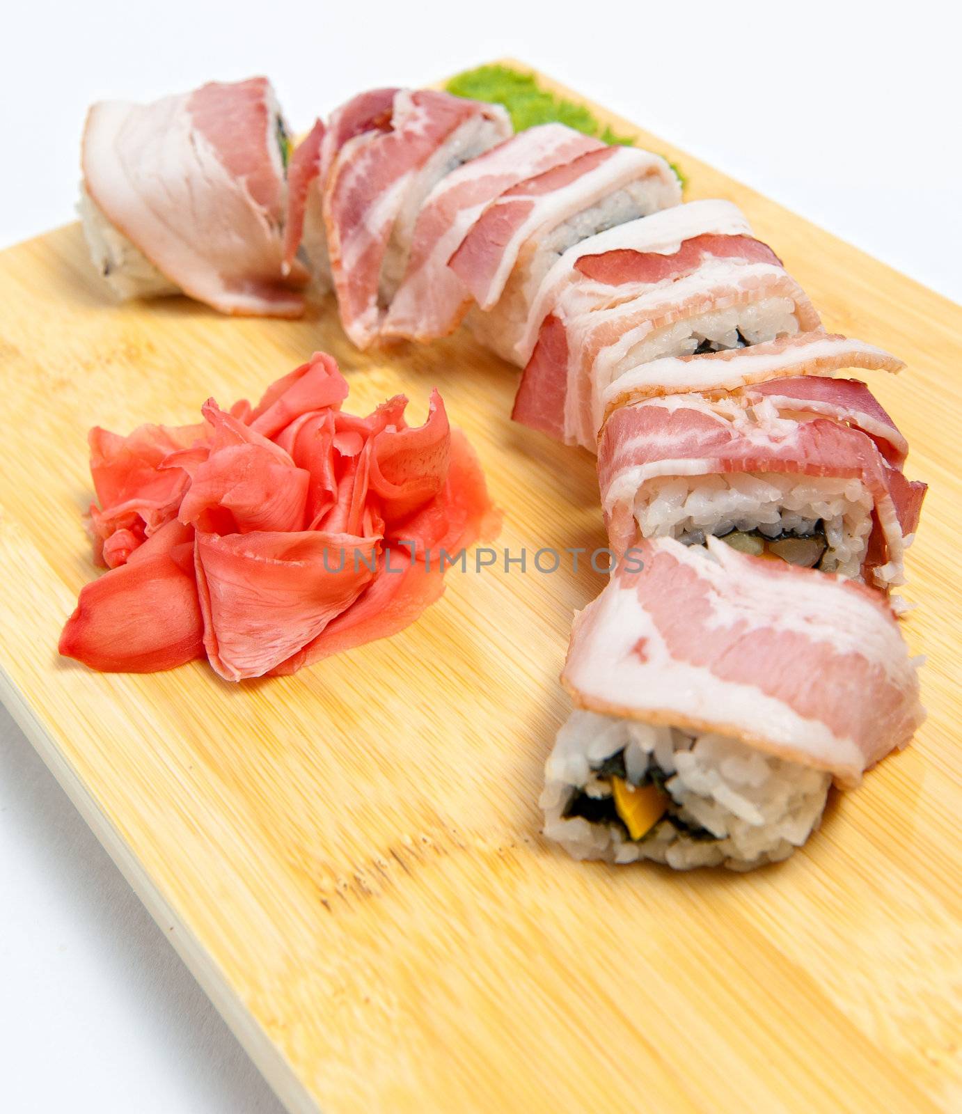 Rolls with bacon on wooden stand isolated on white background