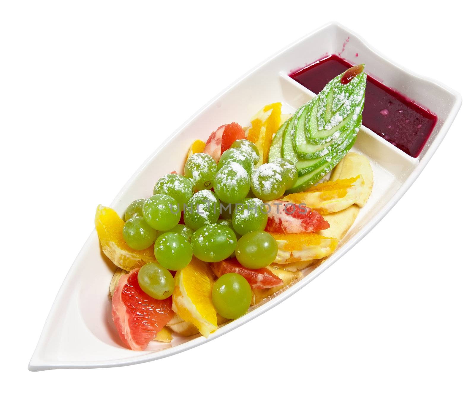 Assorted fruit in a dish in the form of a boat isolated on white