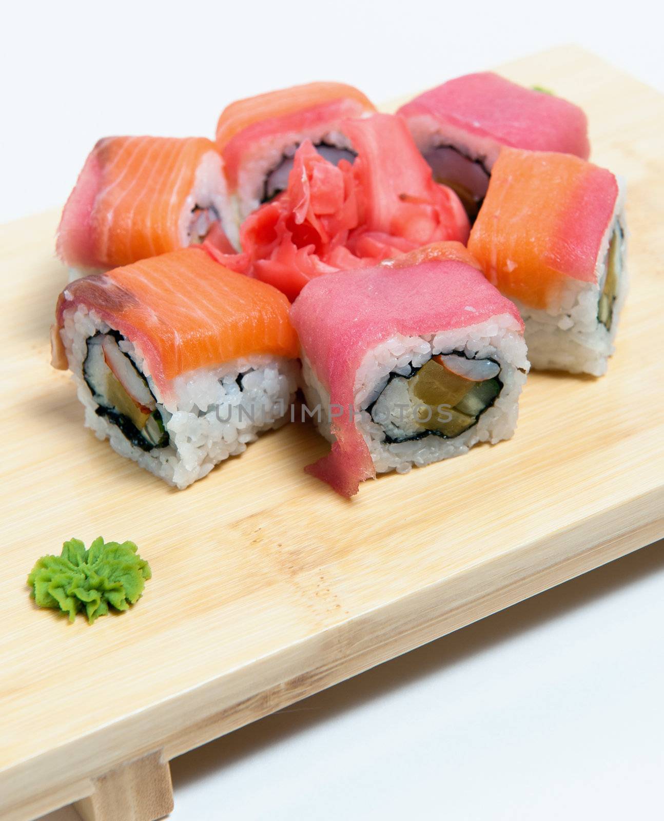 rolled sushi on  wooden stand isolated on white background