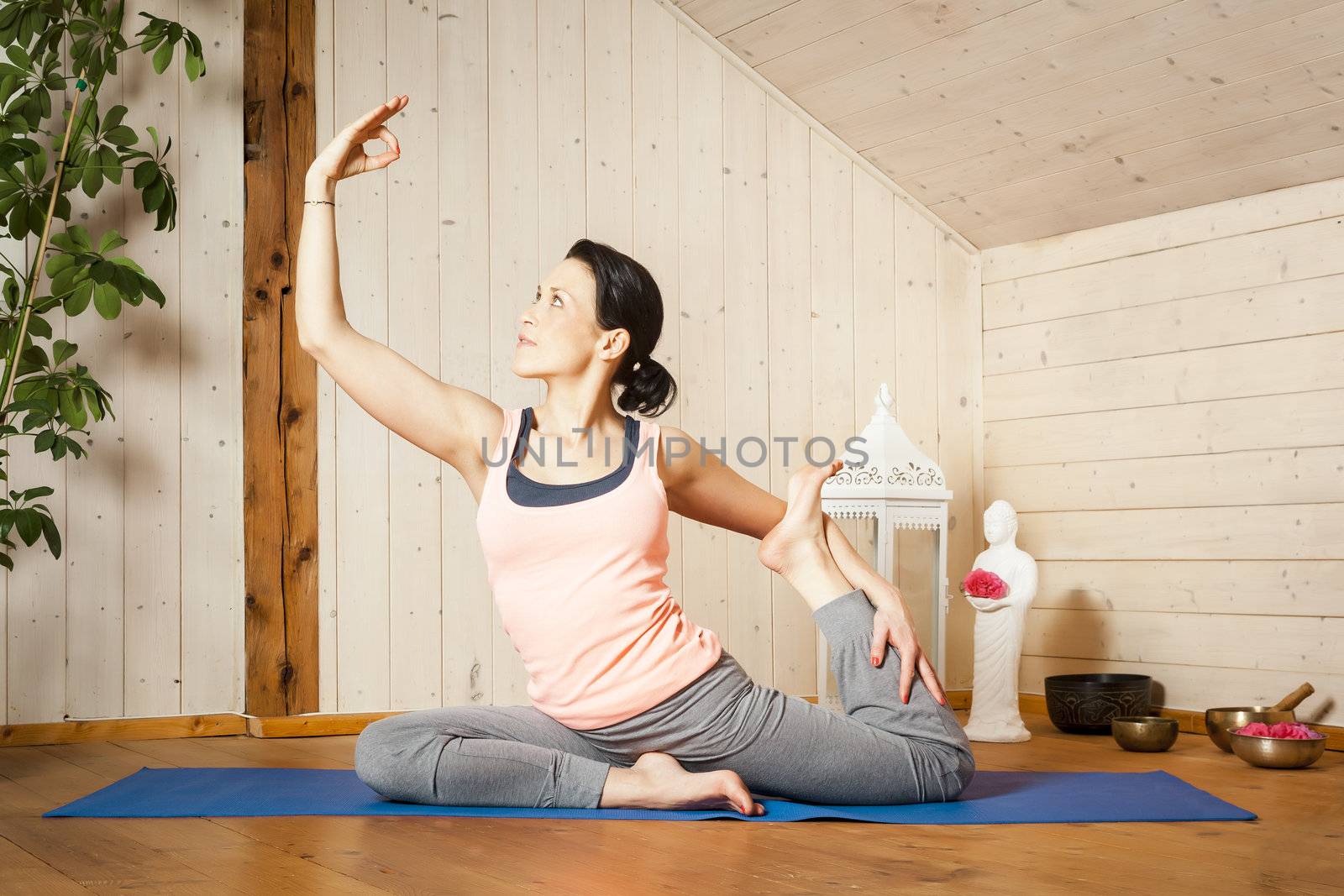 An image of a pretty woman doing yoga at home -