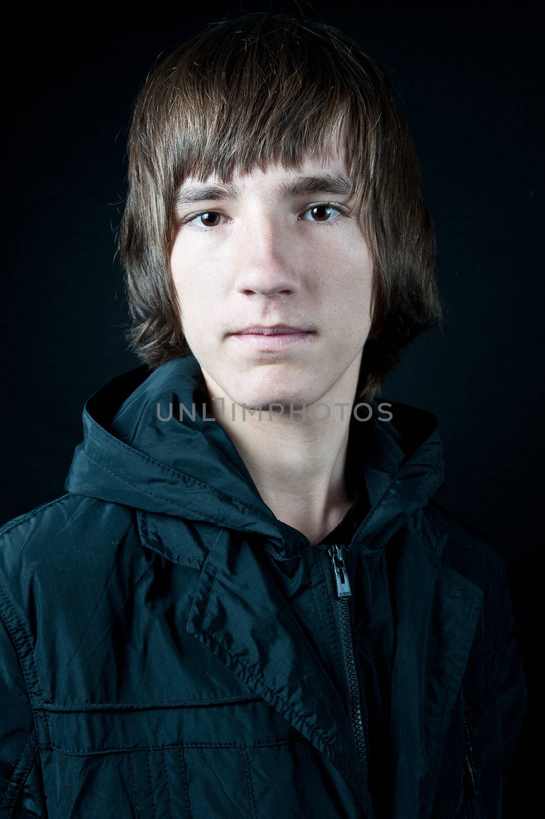 young man in the jacket on a black background