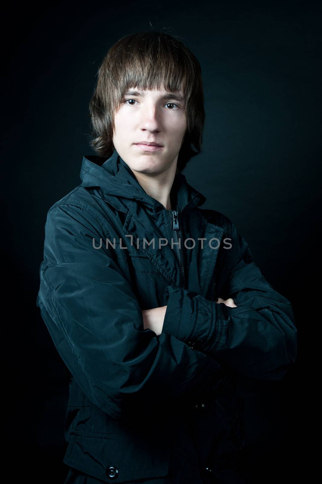 young man in the jacket on a black background