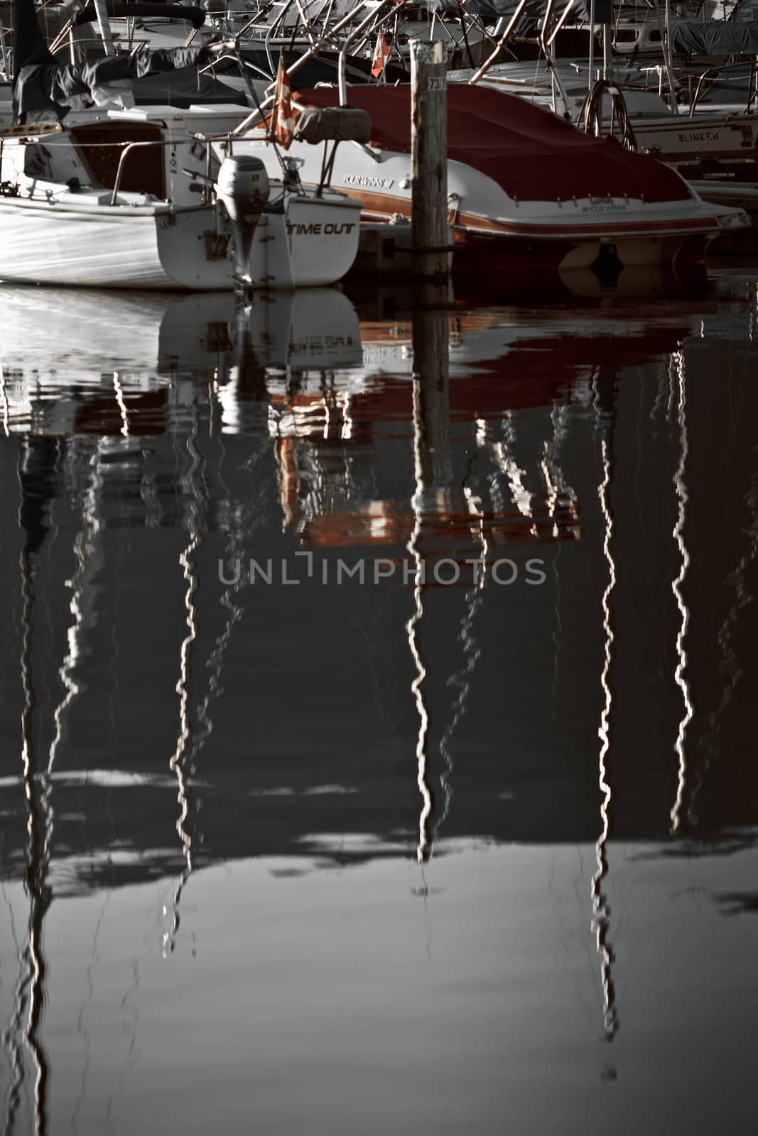 Boats and reflections of yachts in still water