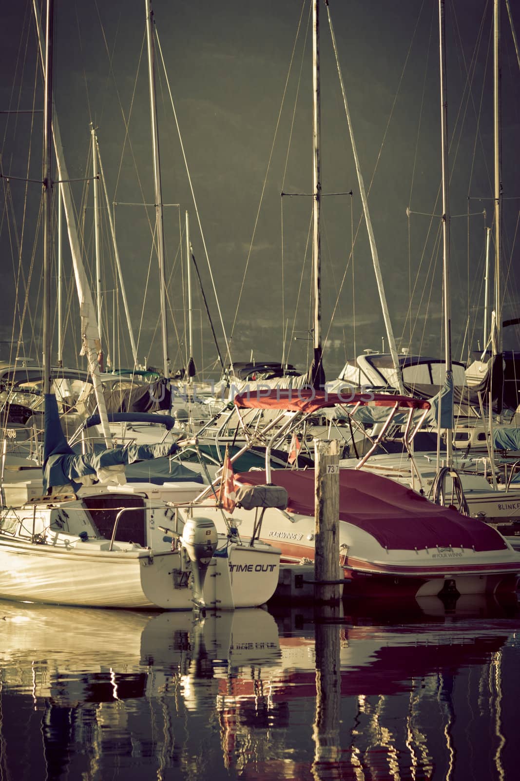 Boats and reflections of yachts in still water