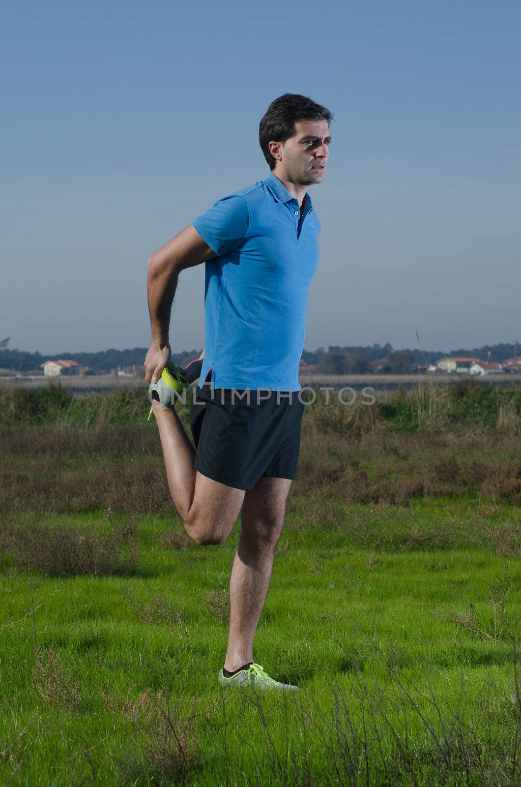 Male runner exercising outdoors on country landscape.