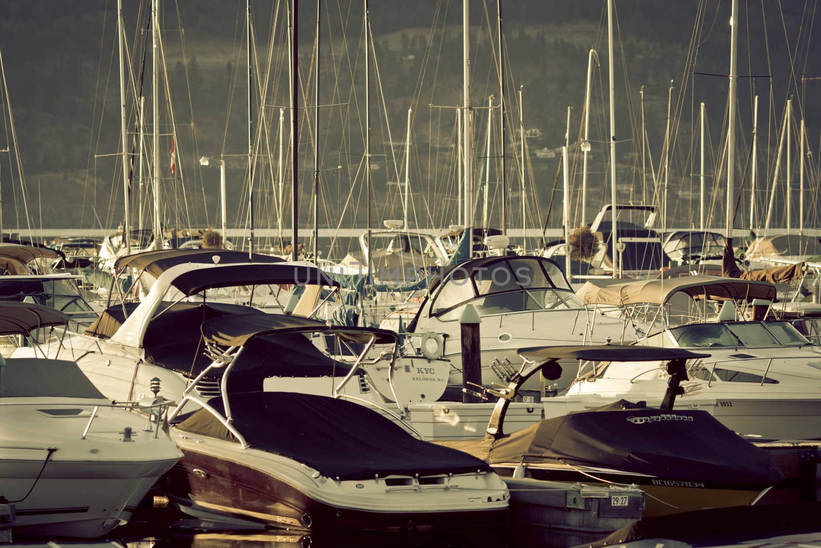 Boats and reflections of yachts in still water