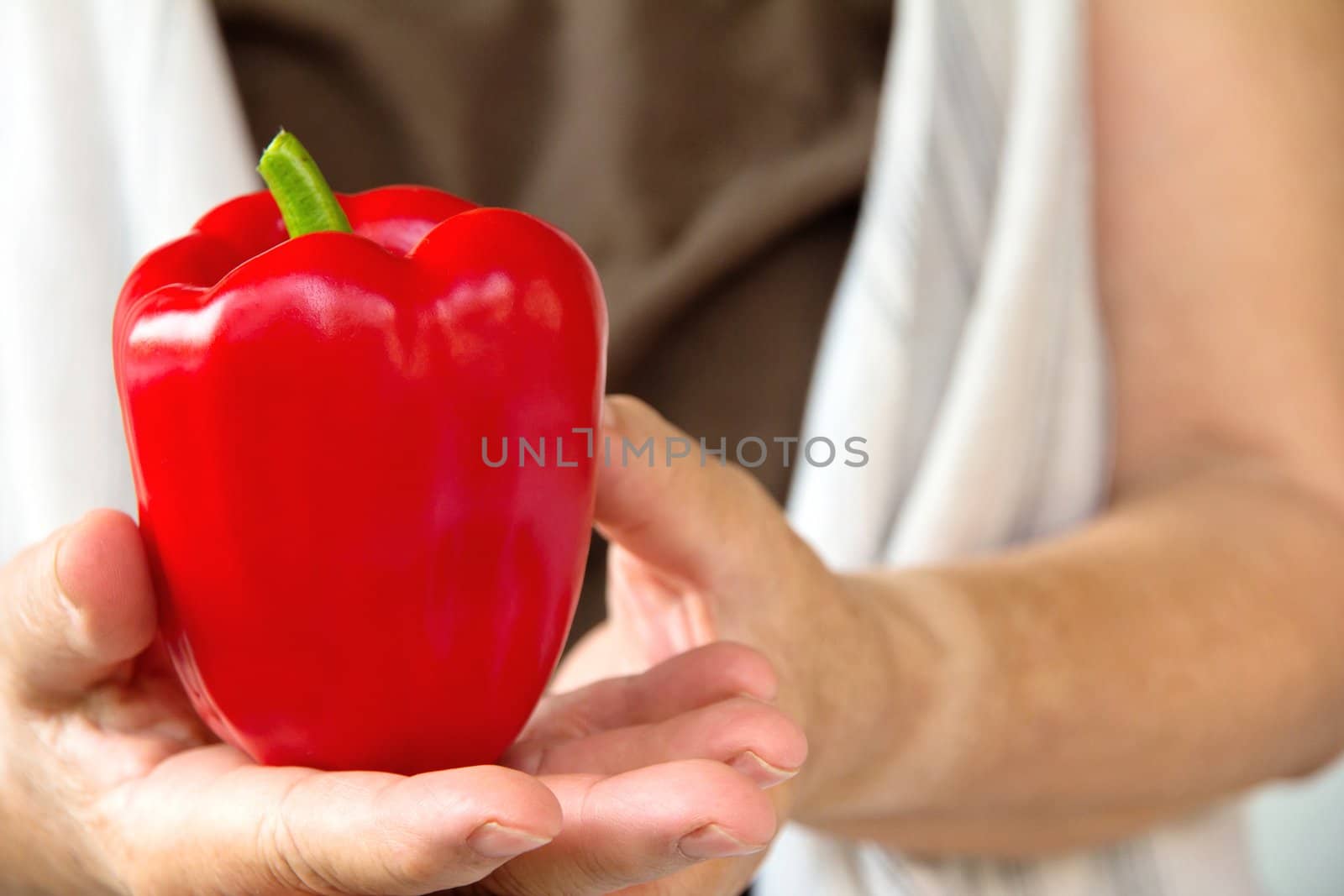 hand holding sweet pepper by ponsulak