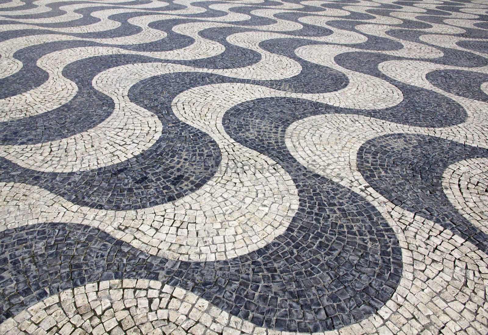 Portugal. Lisbon. Typical portuguese cobblestone hand-made pavement 
