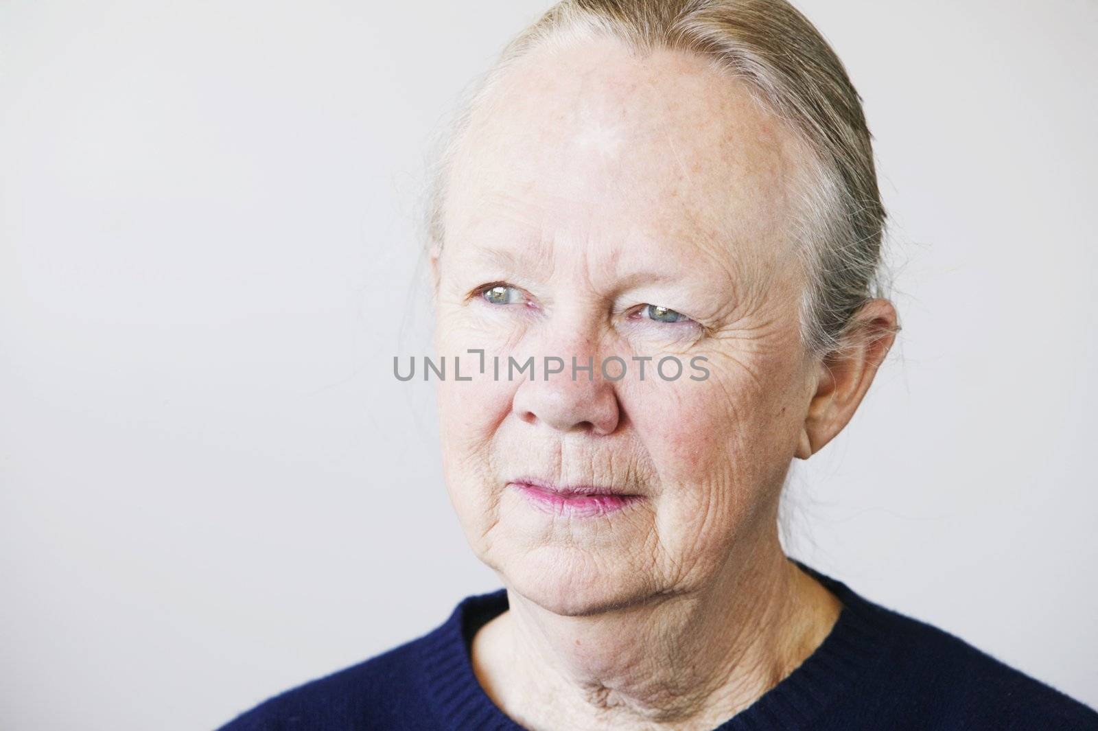 Portrait of a senior woman looking towards a light source.