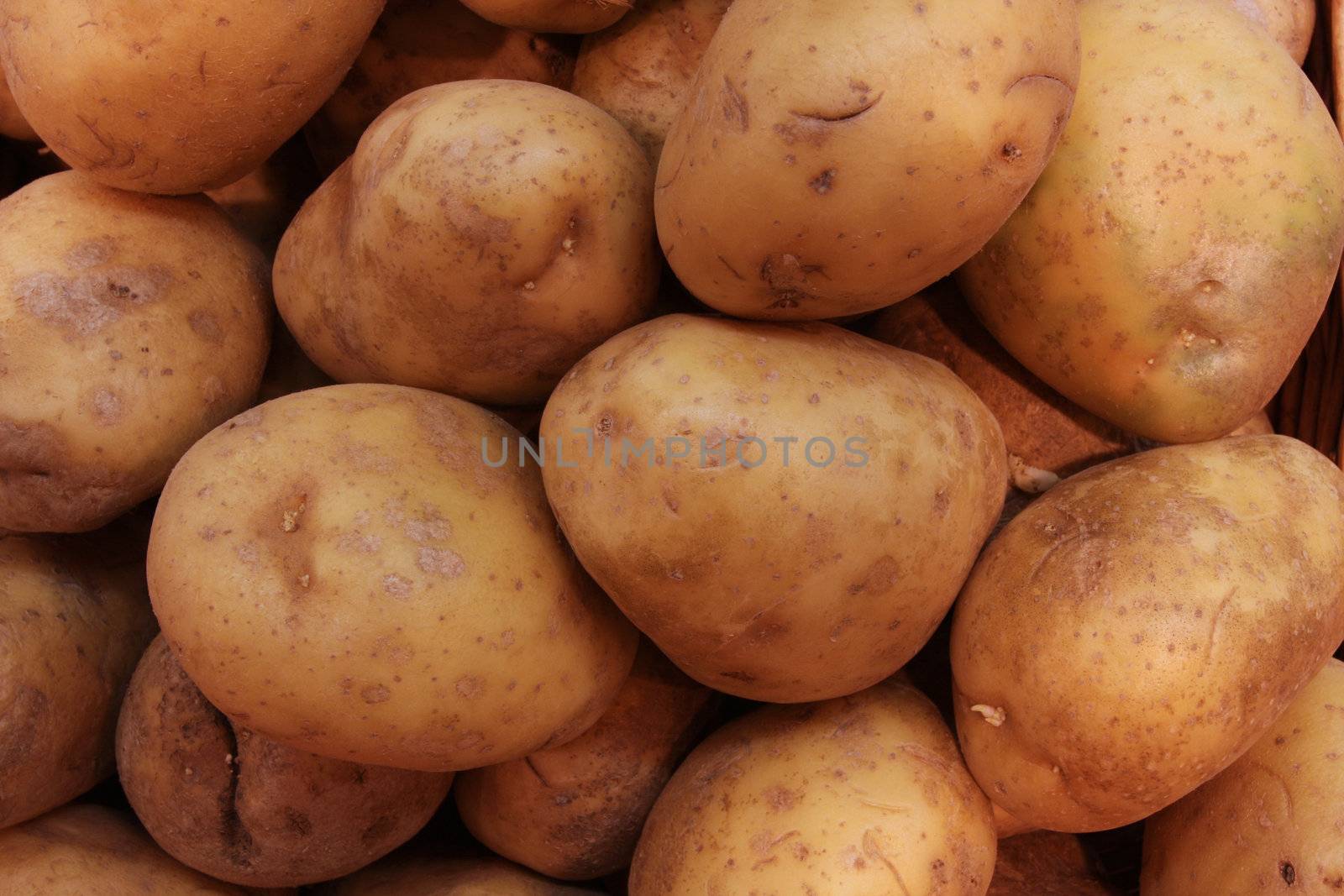 a pile of potatoes in a farmers market