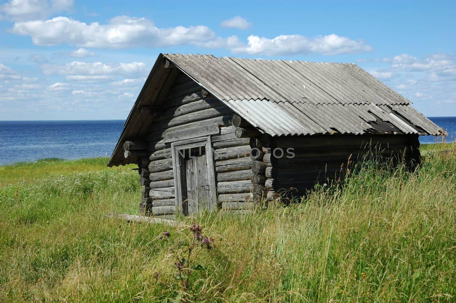 Old wooden shed on the lake bank by wander