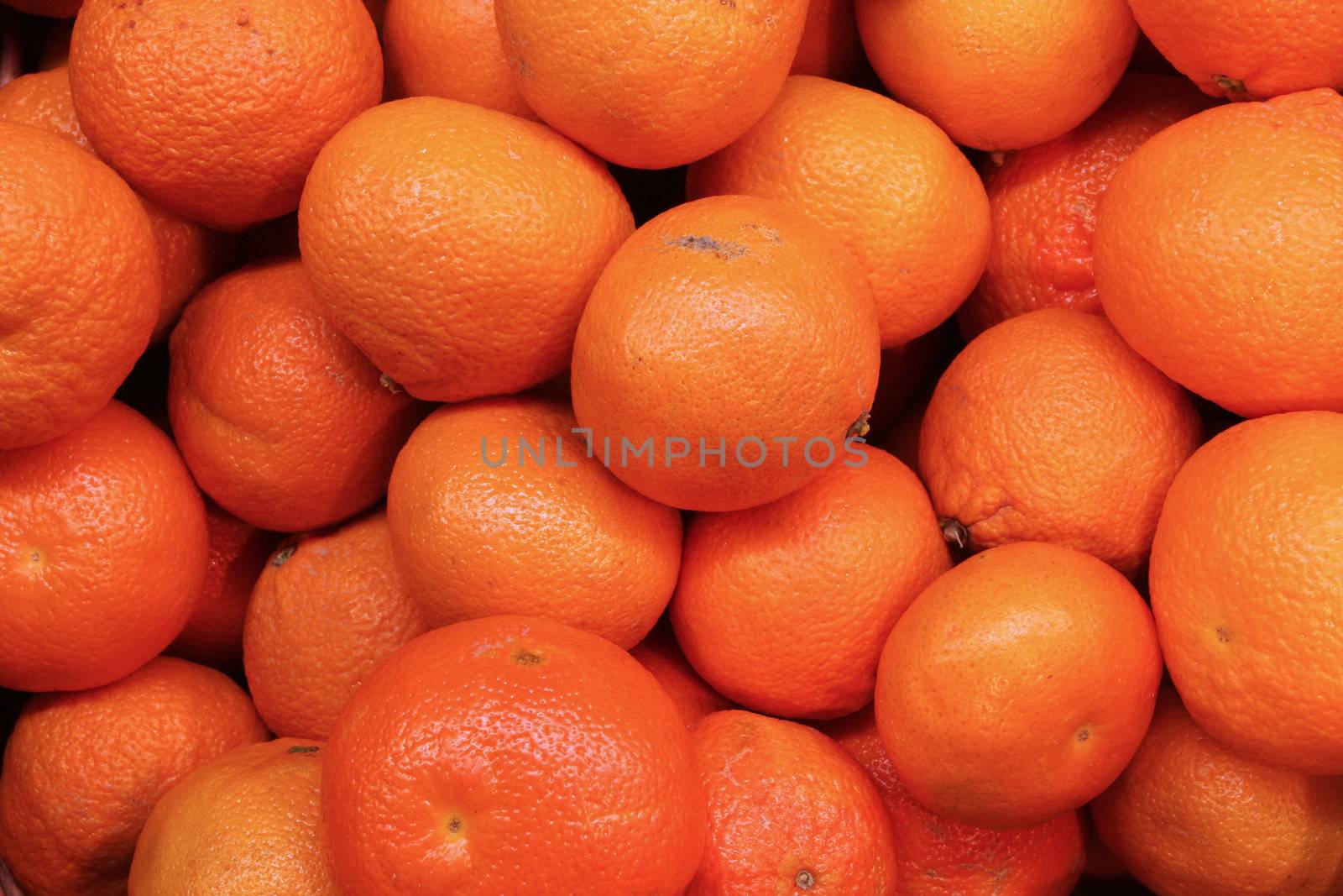 frame filling shot of clementines at a farmers market,great detail, fantastic for your designs