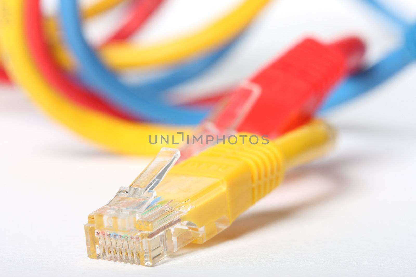 Category 5 network cables isolated on white, three different colors,red,blue and yellow